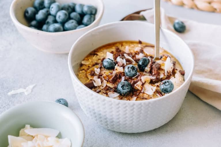 Oatmeal Topped With Banana, Chocolate, Shredded Coconut And Blueberries