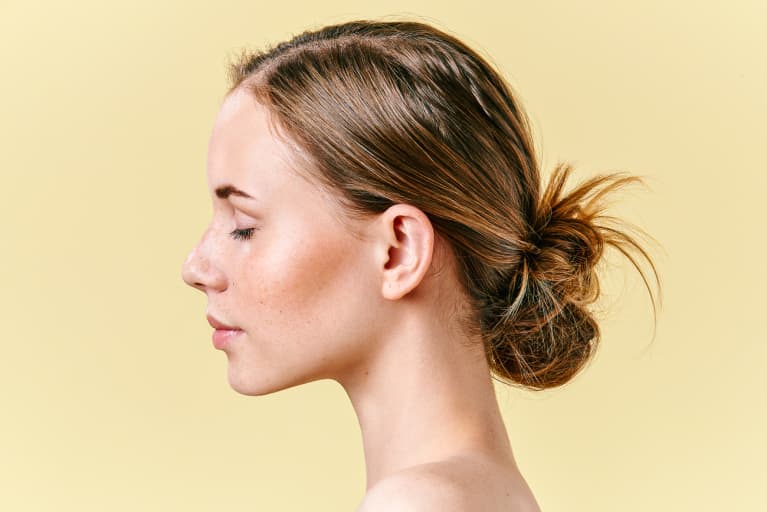 redhead woman with freckles studio profile portrait