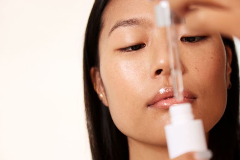 woman applying face oil woman applying face oil