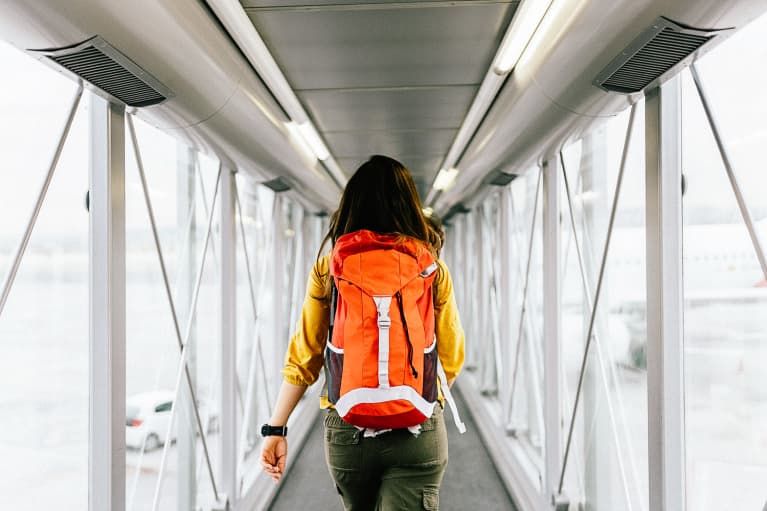 Woman Walking to Airplane Gate at Airport Woman Walking to Airplane Gate at Airport