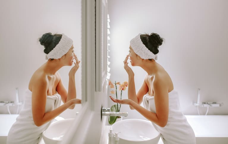 Young Woman Exfoliating Her Face
