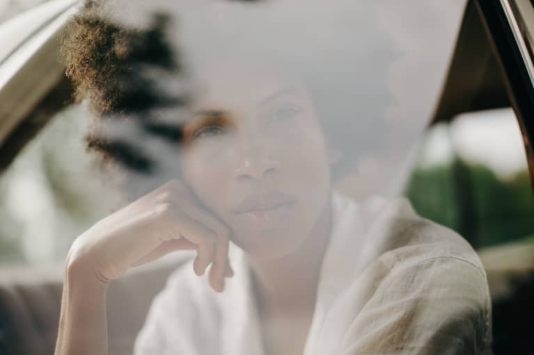 Black Woman Looking Out A Car Window