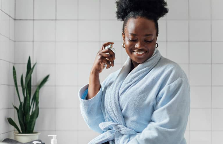 woman spraying perfume