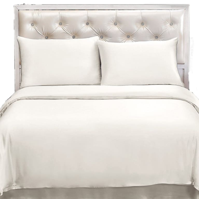 luxurious grey bed with light silk sheets