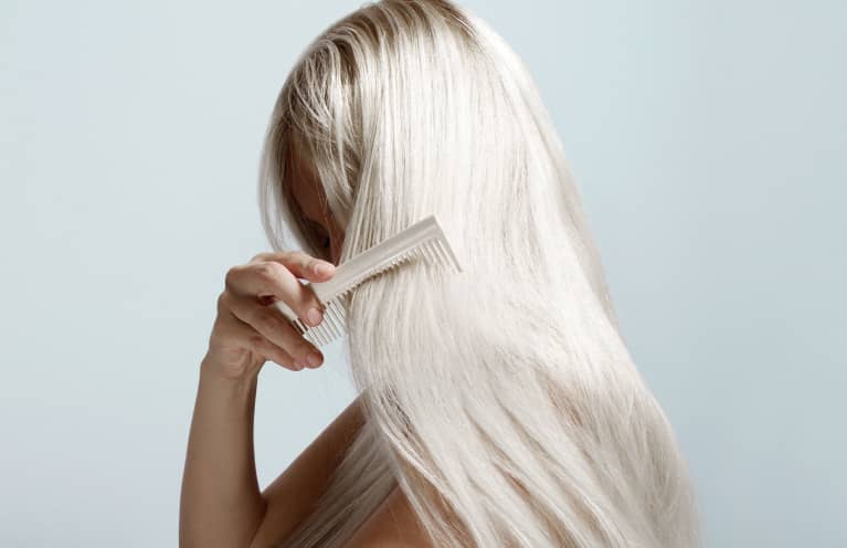 Woman Combing Long Blond Hair Woman Combing Long Blond Hair