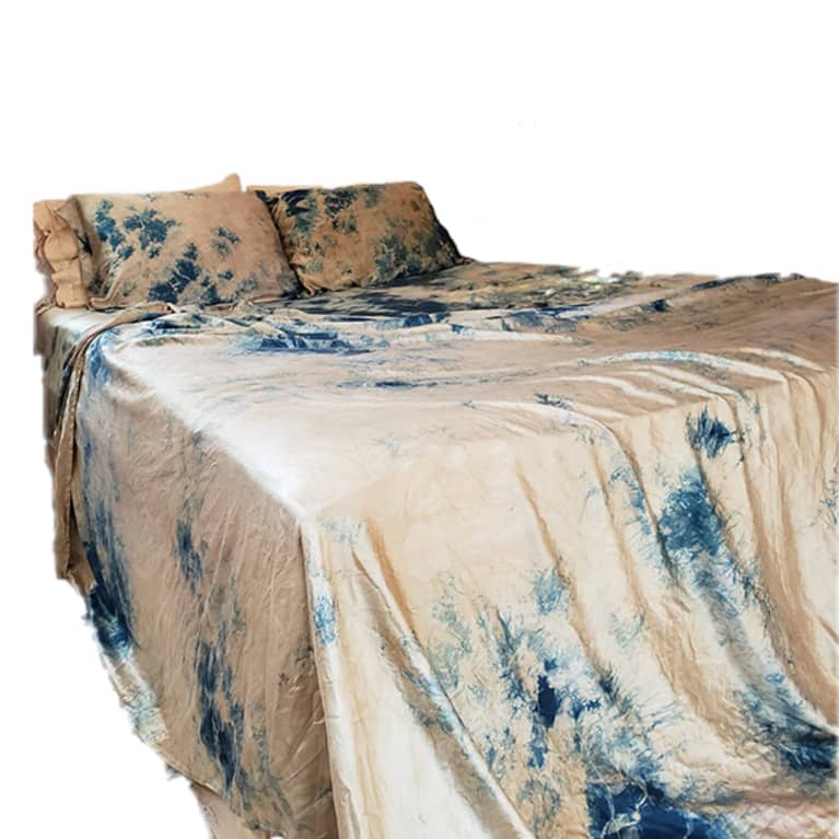 bed made with tie dye silk sheets in blue and tan pattern bed made with tie dye silk sheets in blue and tan pattern