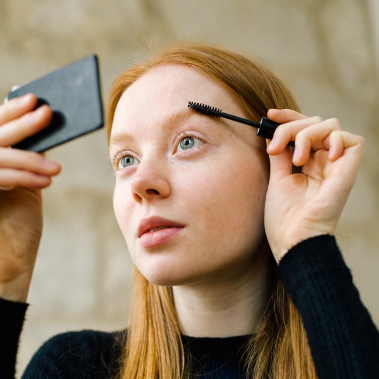 Young Woman Putting On Make-Up