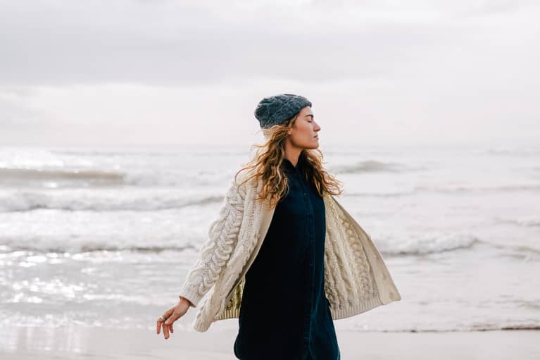 Woman on the Beach in Wintertime Soaking in the Moment Woman on the Beach in Wintertime Soaking in the Moment