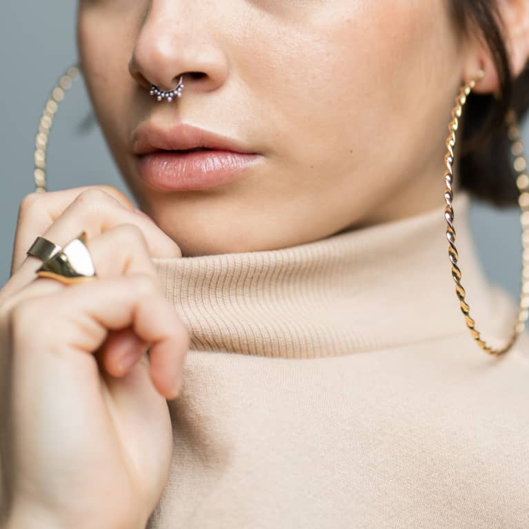 Unrecognizable Woman with Turtleneck and Gold Jewelry
