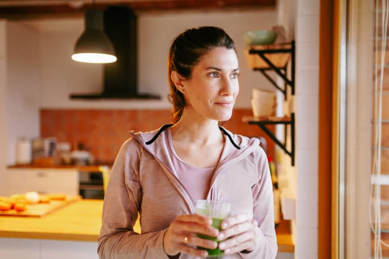 Woman Drinking A Smoothie At Home.