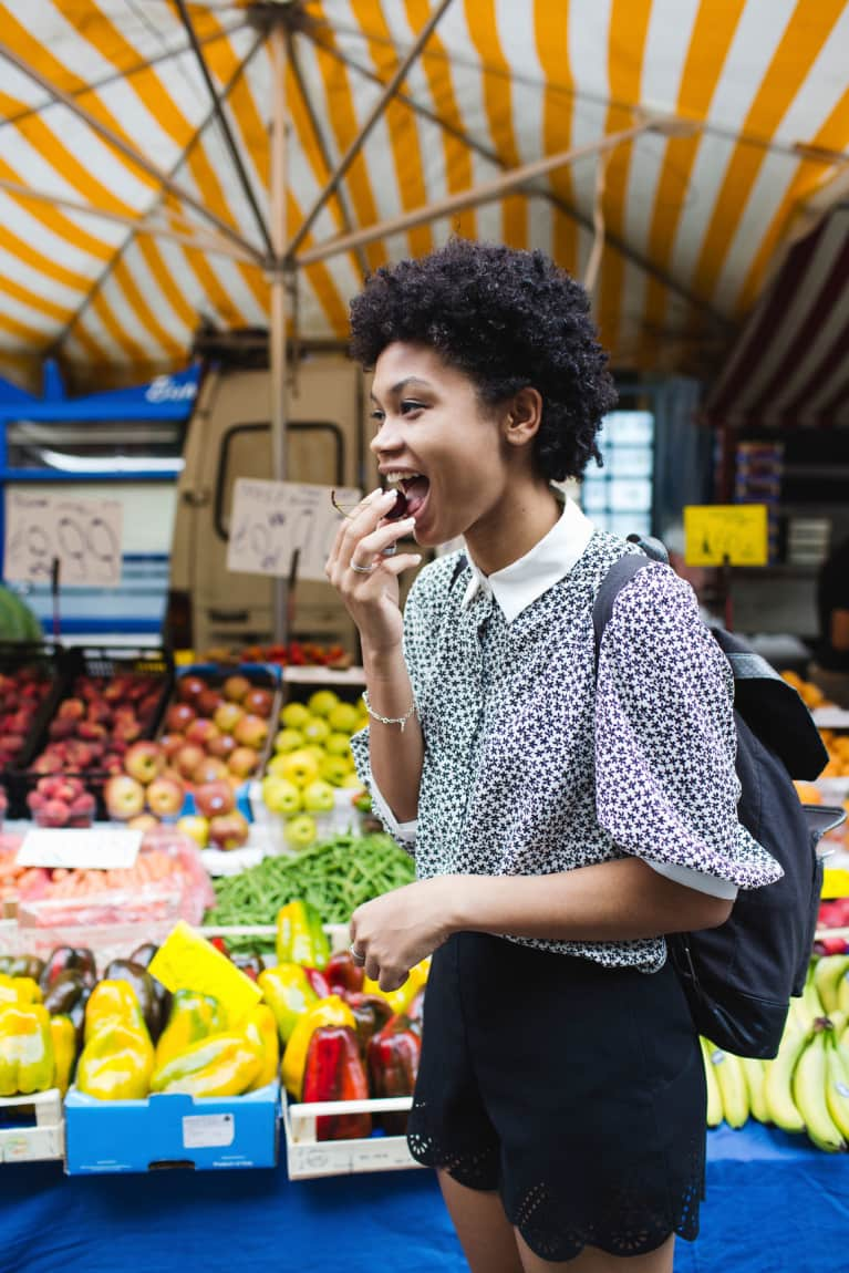 Woman eating food at a market