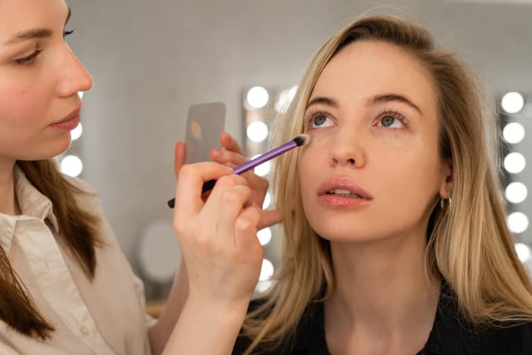 woman getting eye makeup done