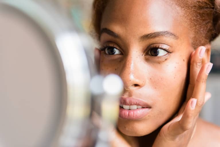 Woman Checking Skin in Mirror Woman Checking Skin in Mirror