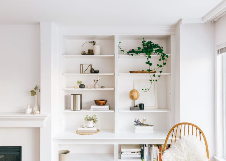 Beautiful Interiors Of Minimal Home With Bookshelf, Furniture, Rug And Plants